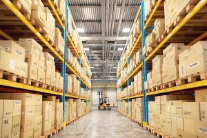 forklift between rows in warehouse